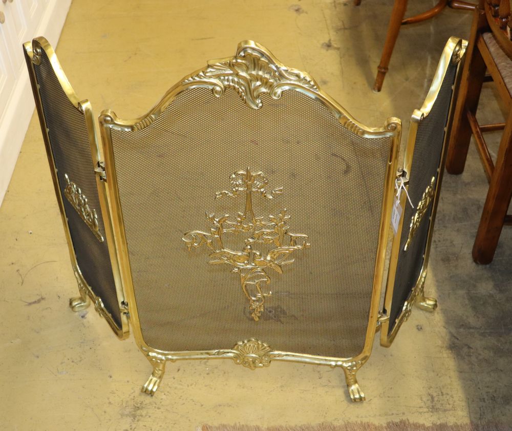 A Louis XV style gilt metal framed triple spark guard, W.110cm, H.80cm